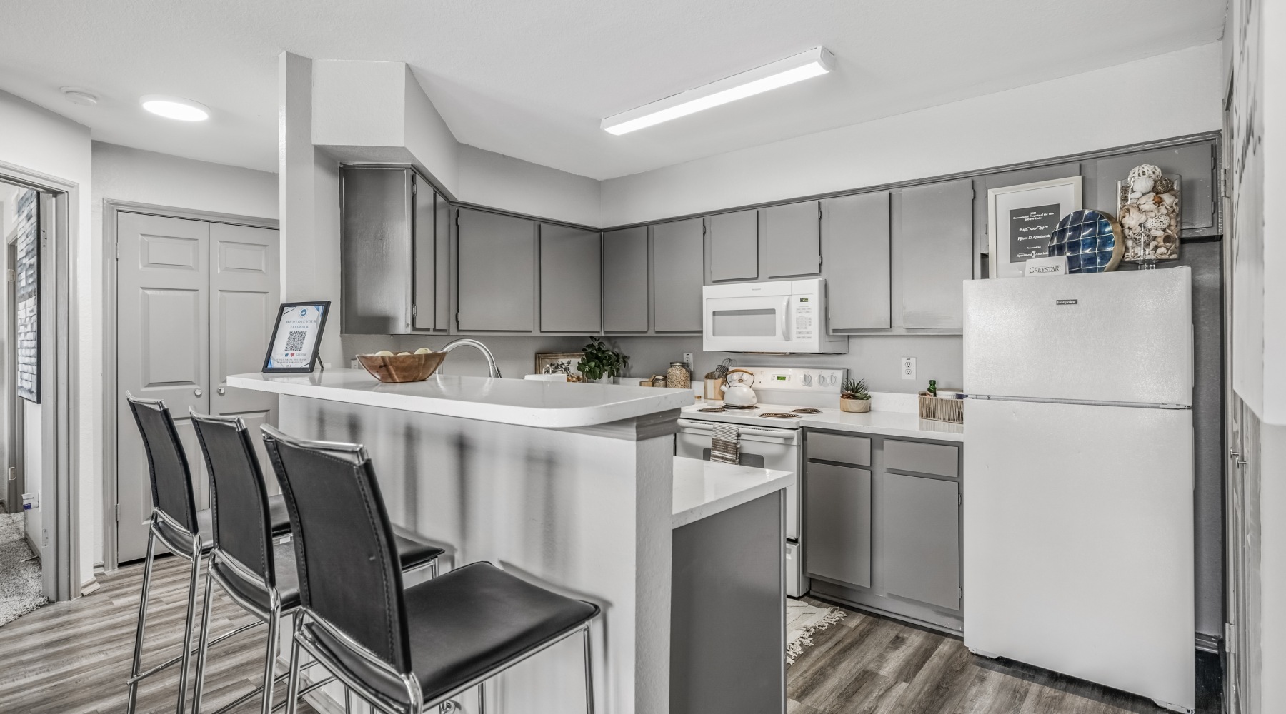 bright kitchen with appliances and serving counter