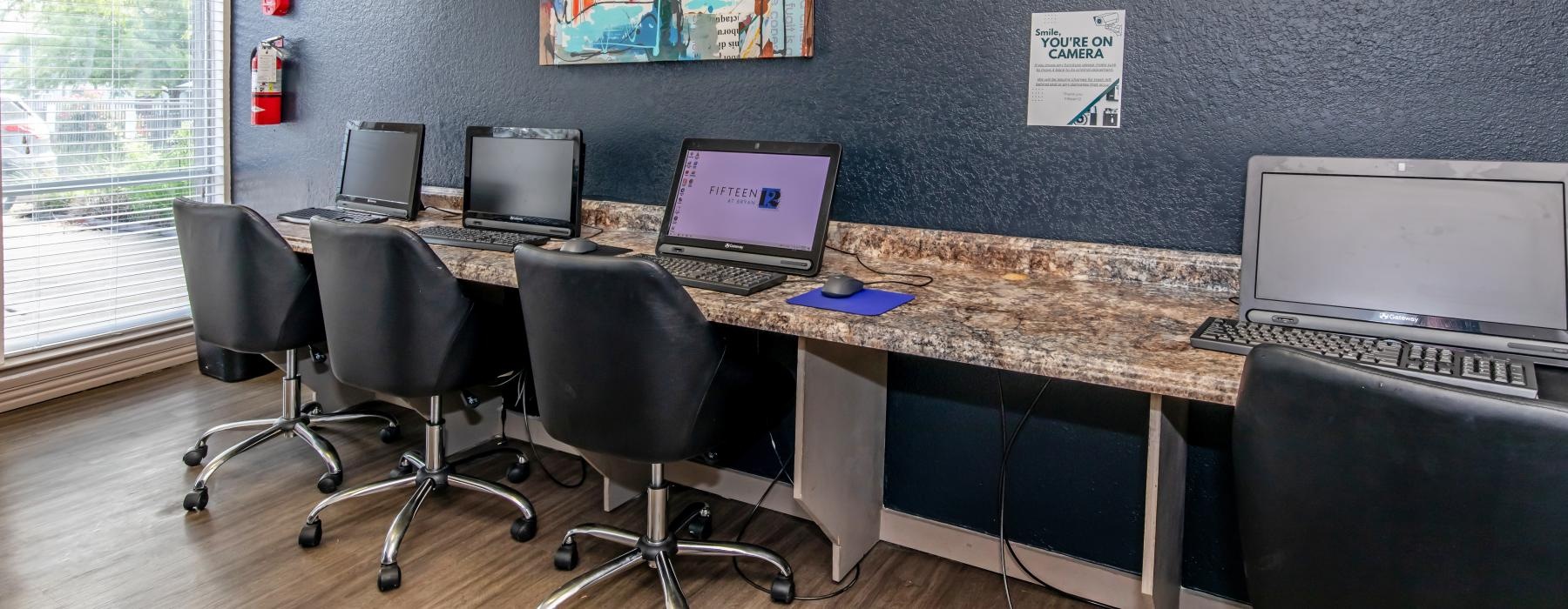 a desk with several computers