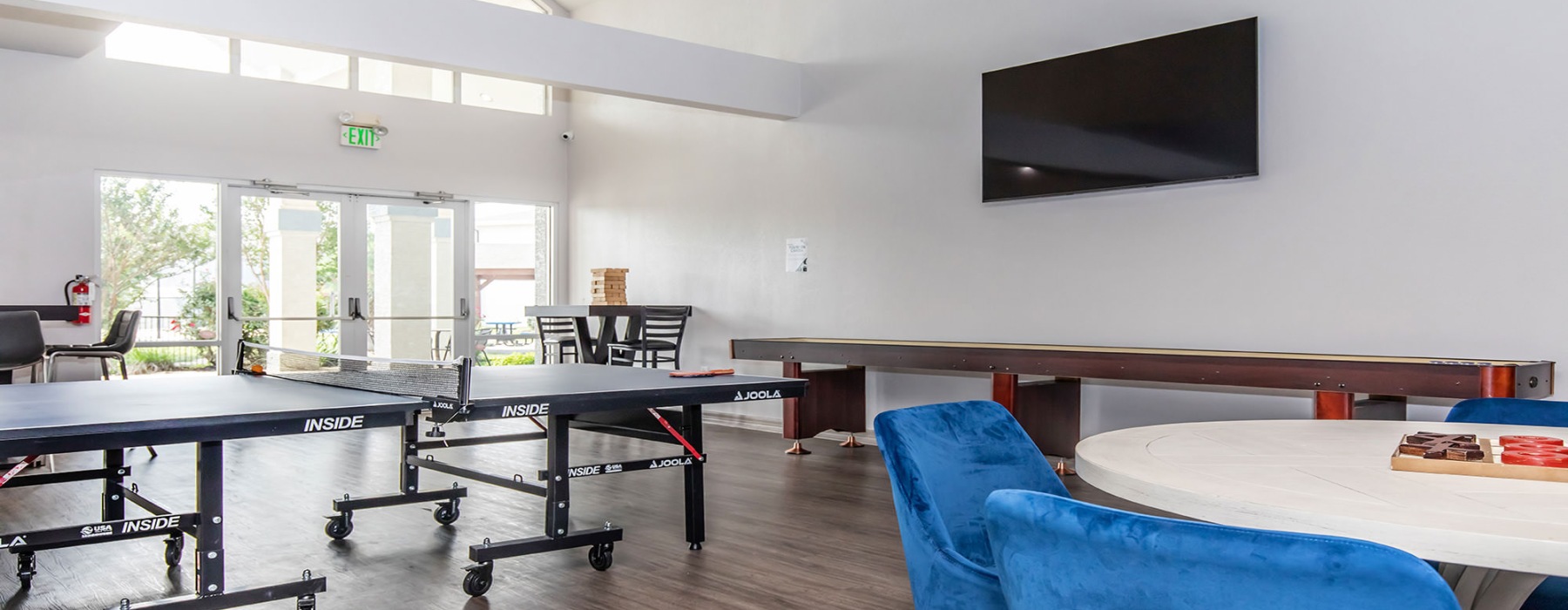 Game room with ping pong table, shuffleboard, and more at Fifteen12 Bryan homes for rent in TX.	