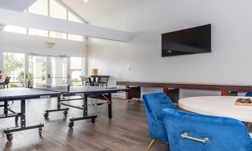 Game room with ping pong table, shuffleboard, and more at Fifteen12 Bryan homes for rent in TX.	